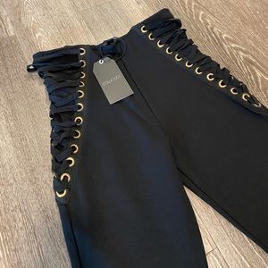 Black pants stretch with gold details.